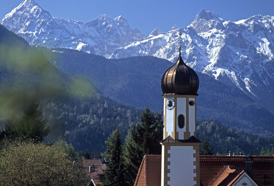 Verschneite Berge des Karwendel, im Vordergrund die Wallgauer Kirche, © Alpenwelt Karwendel | Wenzel Fischer 