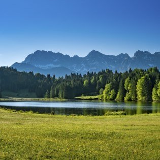 Lush shades of green at Schmalensee near Mittenwald with a view of Karwendel mountains, © Alpenwelt Karwendel | Paul Wolf