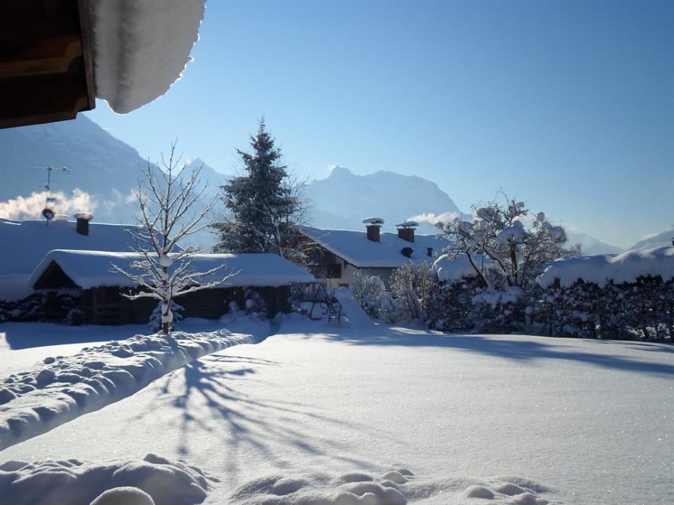 Garten mit Almhütte.